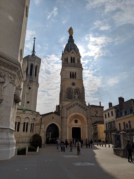 The bell tower with a golden statue of Mary at the top